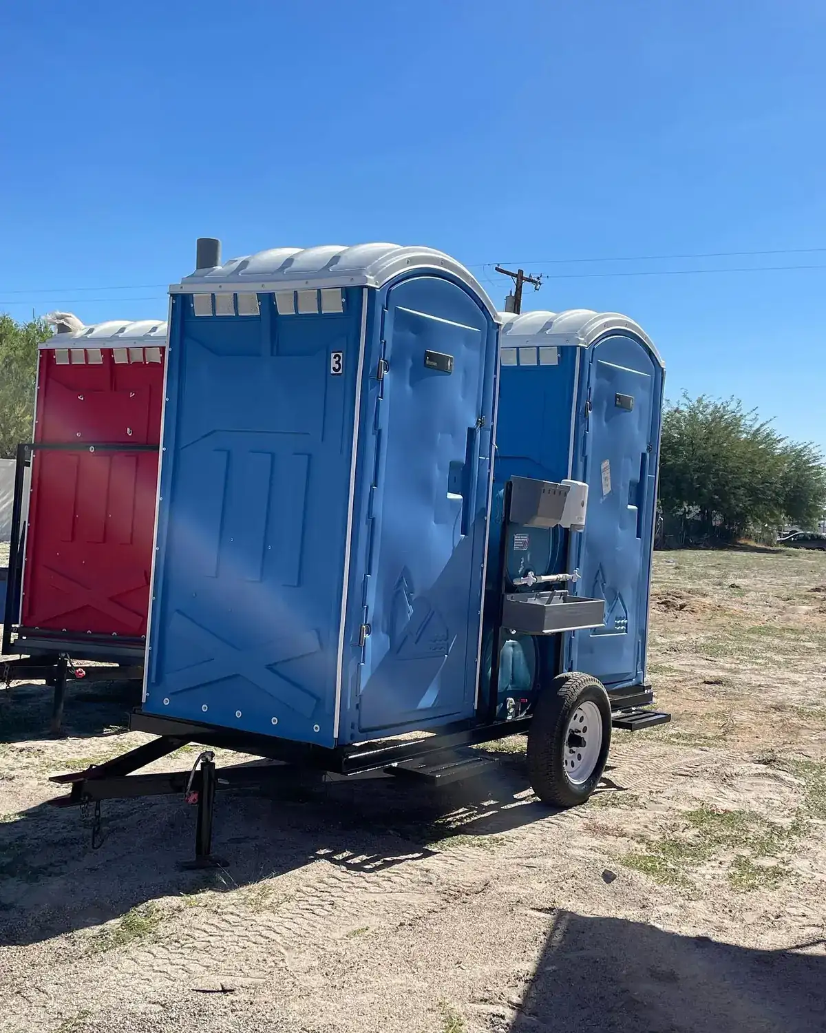 Portable toilet mounted on a small towable trailer